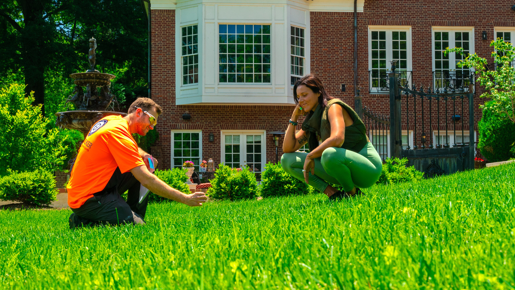 lawn control technician with customer doing inspection