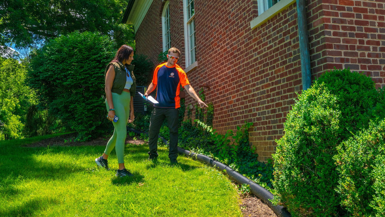 pest control technician with customer doing inspection