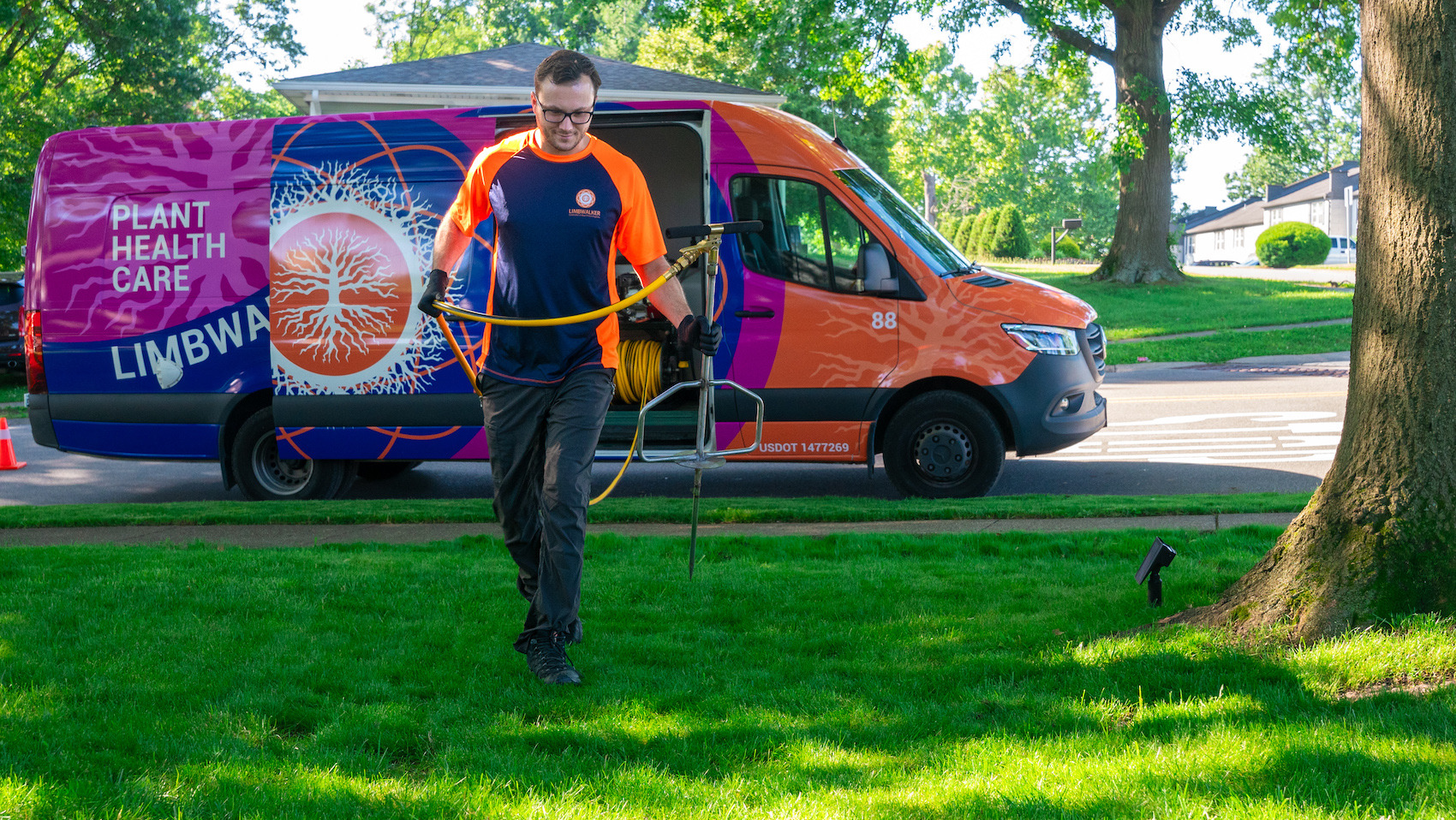 plant health care technician getting ready to fertilize tree