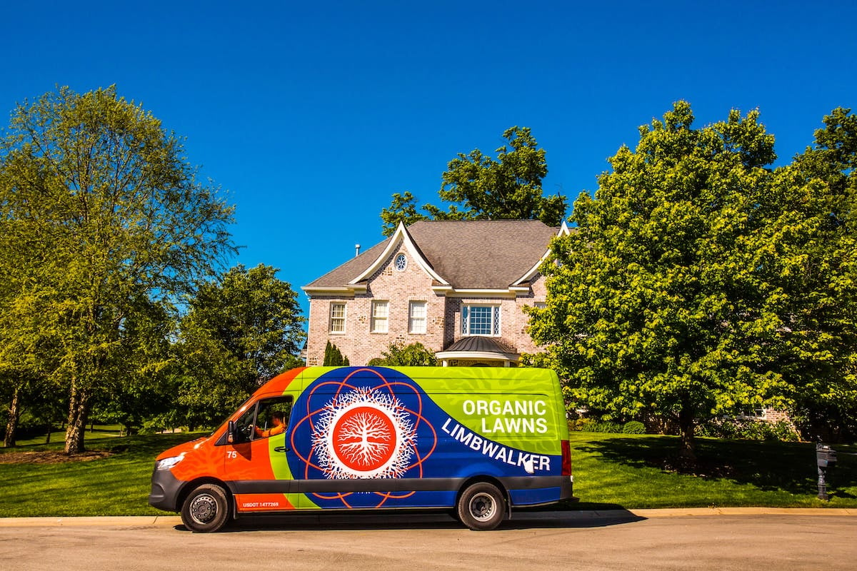 lawn care van in front of customer house