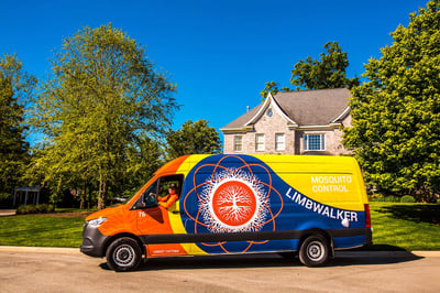 mosquito control expert in front of house in truck 