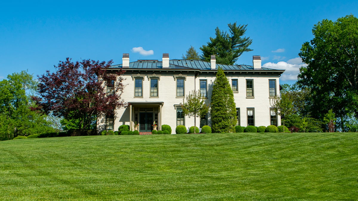 house with mature plants in front yard 