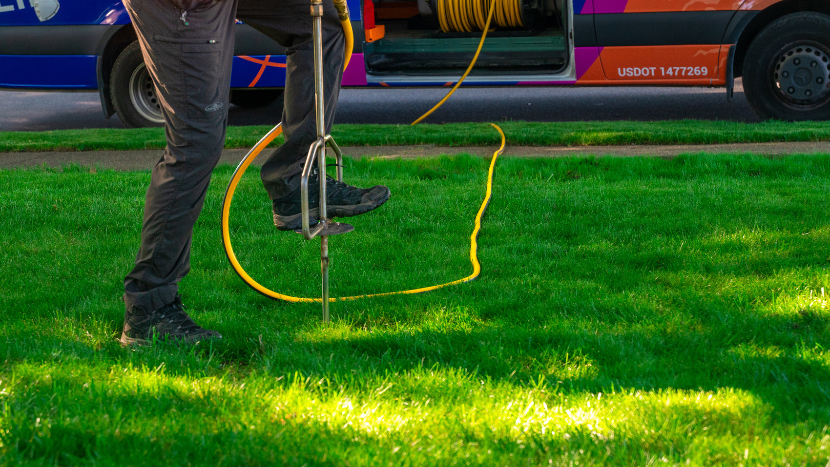 technician getting ready to fertilize tree roots